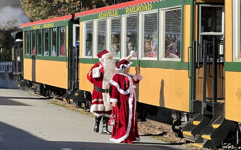 Mr. and Mrs. Clause wave to children on the Edaville Train